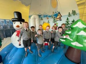 Children enjoying holiday activities at Inchmarlo indoor play area with snowman decorations.