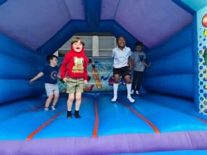 Children playing in bounce house at Inchmarlo community event.