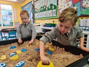 Children playing in sensory sand at Inchmarlo nursery.