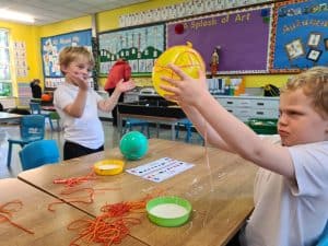 Children engaging in educational toys and activities at Inchmarlo nursery.