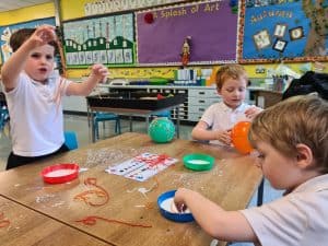 Young children engaging in art activities at Inchmarlo's early learning center.