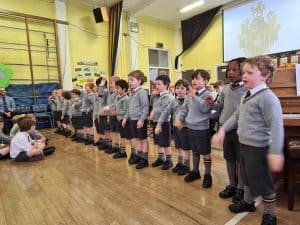 Children singing performance at Inchmarlo School event.