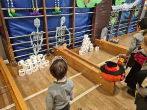Children playing with holiday-themed decorations at Inchmarlo Scottish retirement community.