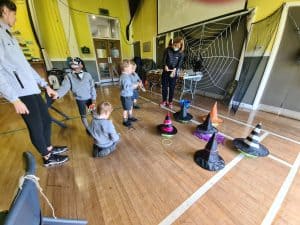 Children enjoying indoor play activities at Inchmarlo care home in a vibrant, colorful environment.