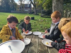 Children enjoying outdoor meal at Inchmarlo outdoor dining area.