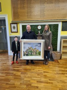 Family presenting framed art at Inchmarlo. Elegant setting with wooden floors and green decor.
