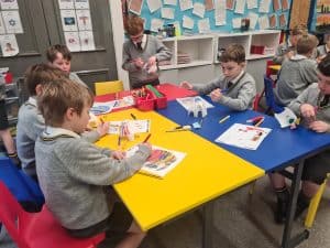 Children engaging in creative activity at Inchmarlo School classroom.