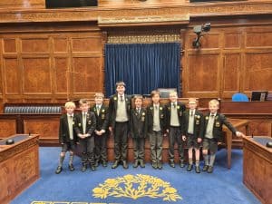 Group of children with teacher at Inchmarlo school assembly hall.