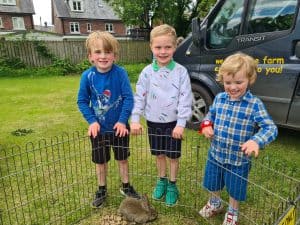 Three children at Inchmarlo outdoor activity center, enjoying fun and learning in scenic surroundings.