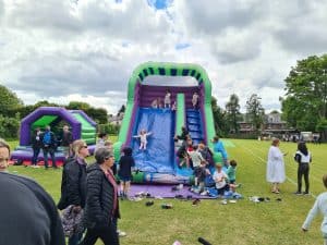 Vibrant outdoor kids' inflatable slides and obstacle courses at Inchmarlo, perfect for family fun and outdoor activities.