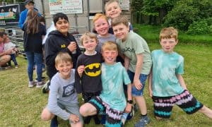 Smiling children at Inchmarlo outdoor activity center in Scotland.