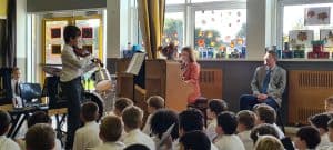 Children watching puppet show at Inchmarlo, an engaging educational environment.