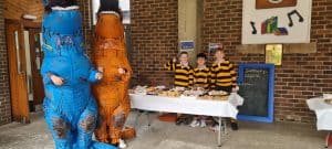 Friends at Inchmarlo charity event in front of a table.