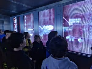 Visitors exploring interactive digital displays at Inchmarlo Museum.