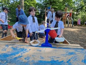 Children playing in outdoor playground at Inchmarlo, enjoying nature and outdoor activities.