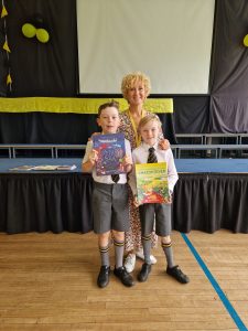 Two children holding books at Inchmarlo school event.