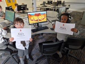 Young students using computers in a classroom setting at Inchmarlo.