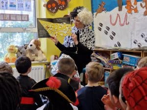 Happy children enjoying storytime with teacher at Inchmarlo School.