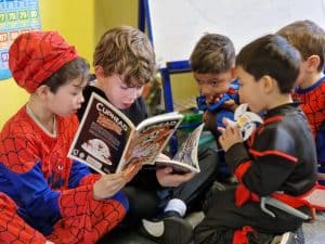 Children reading books together at Inchmarlo Montessori School.