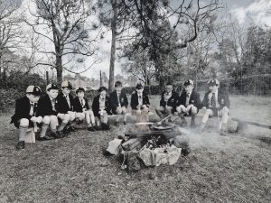 Group of children around a campfire outdoors at Inchmarlo.