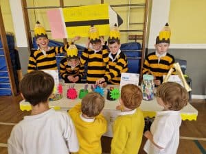Children performing school play in costume for Inchmarlo community event.