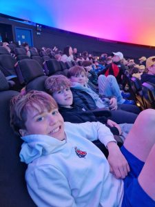 Children enjoying a movie at Inchmarlo Cinema, a family-friendly local attraction.