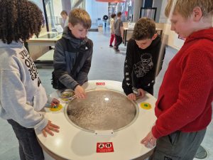 Children exploring a hands-on tactile exhibit at Inchmarlo.