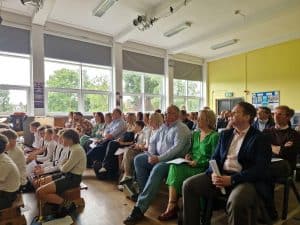 Interior view of Inchmarlo Retirement Community during a group event, showing engaged residents and visitors.