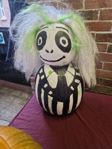 Vibrant panda-themed spooky pumpkin at Inchmarlo event, showcasing festive Halloween decorations and holiday spirit.