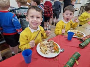 Happy children at Inchmarlo celebrating with lunch at school.