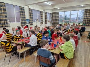Children enjoying festive activities at Inchmarlo School classroom scene.