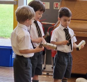 Young students reading educational tablets at Inchmarlo School.