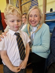 Smiling young student with teacher at Inchmarlo School in Aberdeenshire.