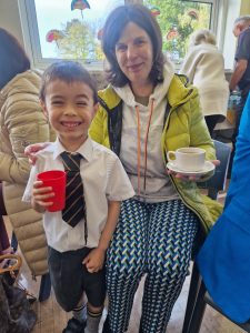 Young boy and woman enjoying tea at Inchmarlo estate event, highlighting scenic location and family-friendly activities.