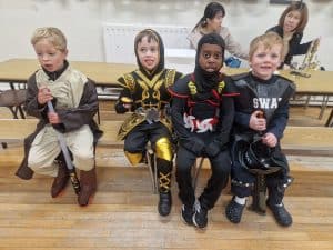 Children dressed in medieval costumes at Inchmarlo, engaging in school activities celebrating history.