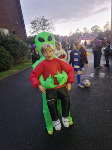 Child dressed as an alien with a green costume at Inchmarlo park.