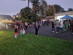 Outdoor community event at Inchmarlo with families and children enjoying festive activities.