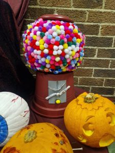Colorful pom-pom decorated pumpkin and Halloween ornaments display at Inchmarlo.