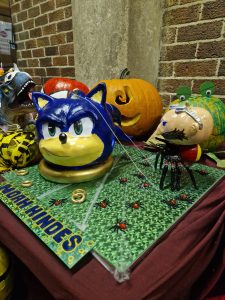 Colorful Halloween-themed decorative pumpkins and figurines display festive atmosphere.
