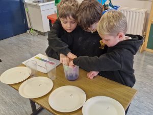 Children engaging in a hands-on activity at Inchmarlo School, fostering learning and creativity.