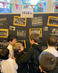Children viewing 1950s themed photos at Inchmarlo historical display.