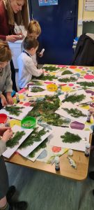 Children decorating festive evergreen arrangements at Inchmarlo.
