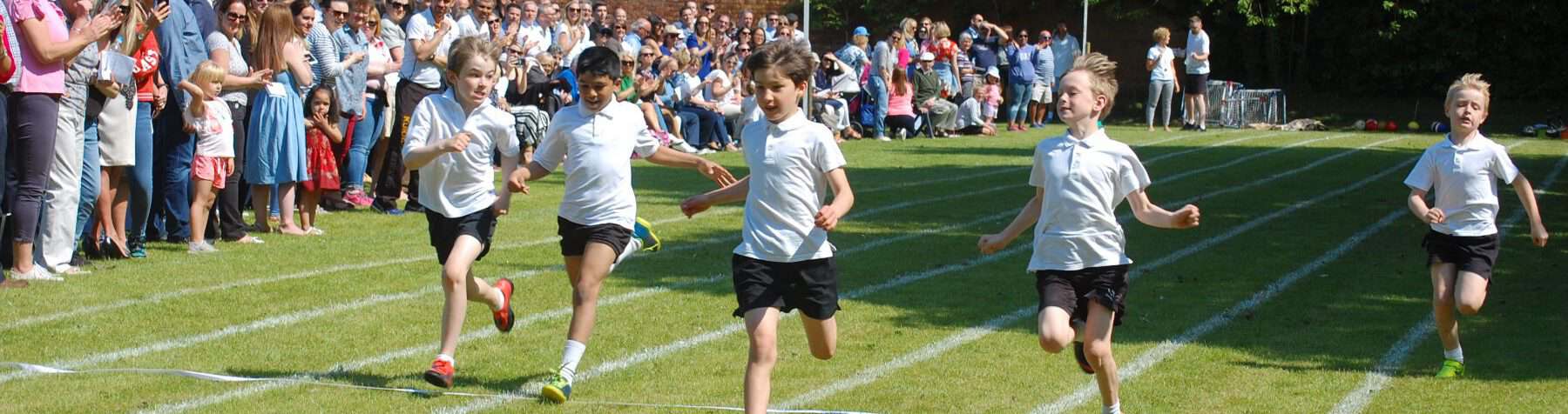 Children running track race at Inchmarlo school sports day.