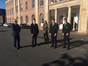 Group of professionals standing outside Inchmarlo estate.