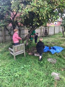 Children playing outdoors in Inchmarlo's lush garden setting.