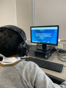 Student using computer at Inchmarlo care home facility for engaging activities.