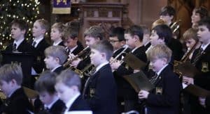 Students performing music at Inchmarlo School in Scotland with uniforms and instruments.