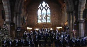 Elegant event in Inchmarlo's historic hall with festive decorations and candlelit ambiance.