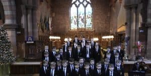 Interior of Inchmarlo Chapel with stained glass windows and family members dressed formally.