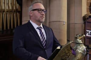 Elegant man in suit at Inchmarlo, Scotland's historic estate.